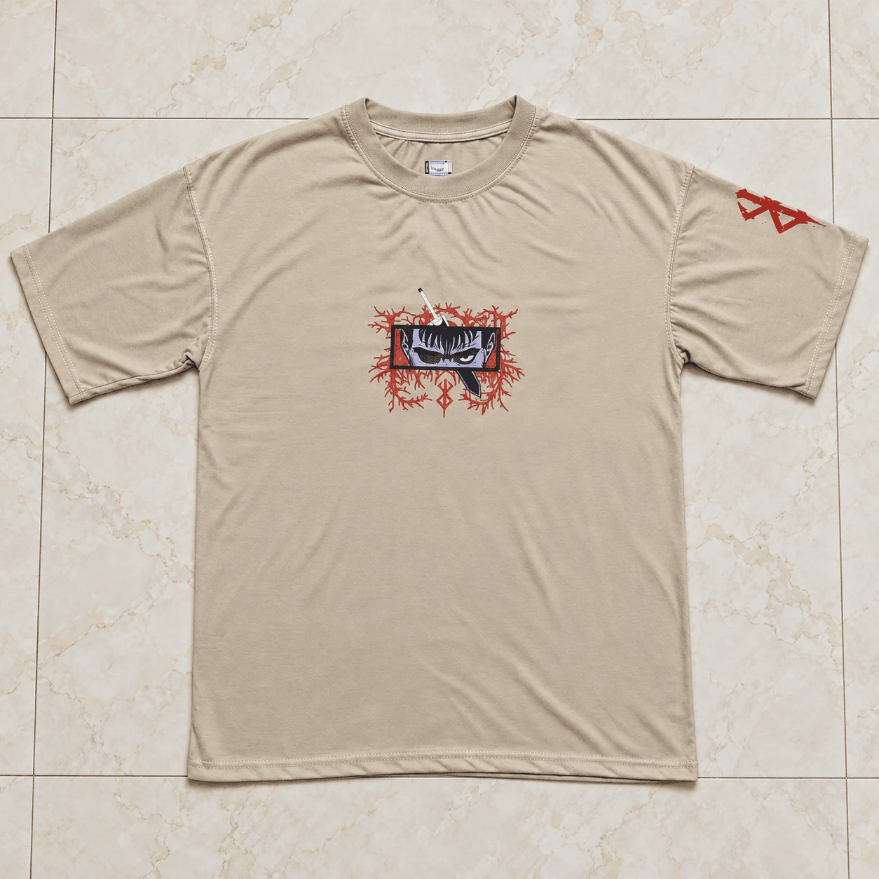 Sand beige drop shoulder tee with Guts Berserk cursed rage eye chest print