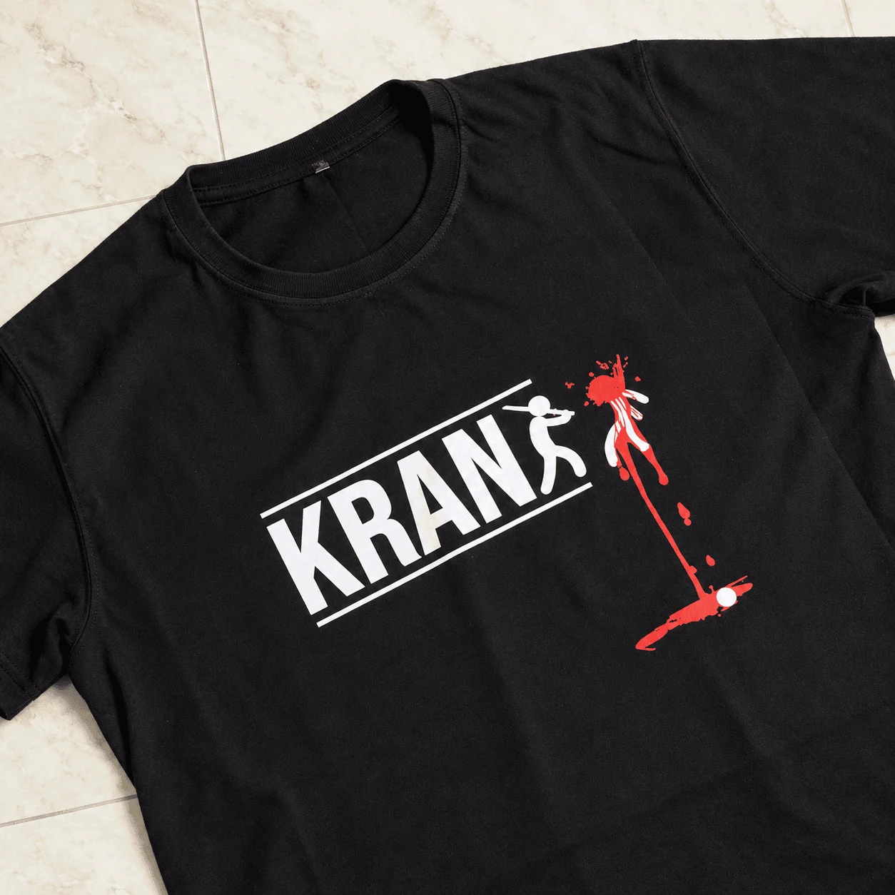 Black streetwear tee with KRANK blood-splatter figure typography print