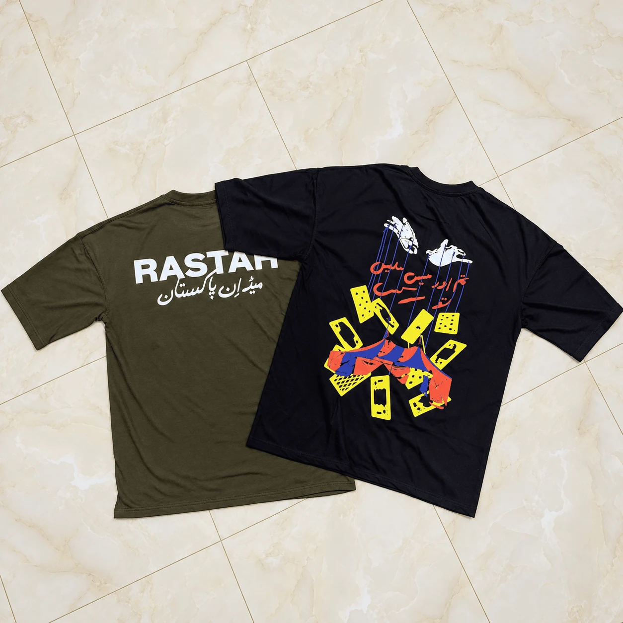 Dual streetwear tees featuring olive Rastaa and black tarot cards graphics