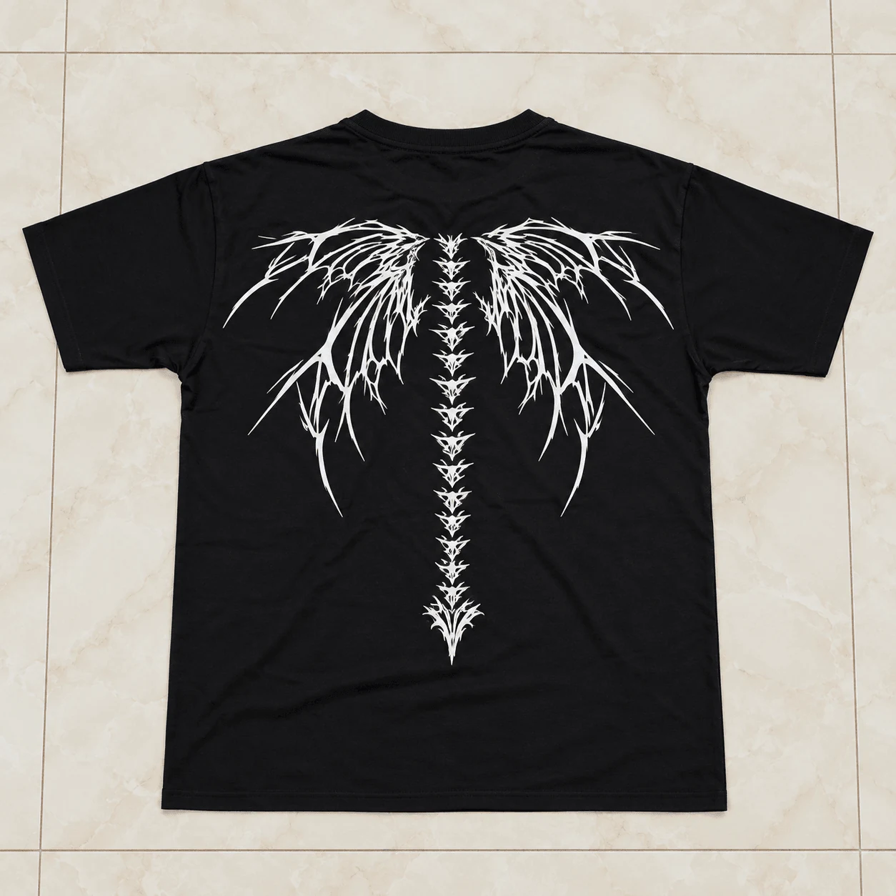 Charcoal black drop shoulder tee with cybernetic biomechanical spine back artwork
