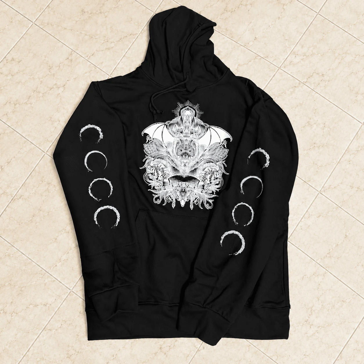 Black heavyweight streetwear hoodie with demon wings chest artwork and moon phases on sleeves