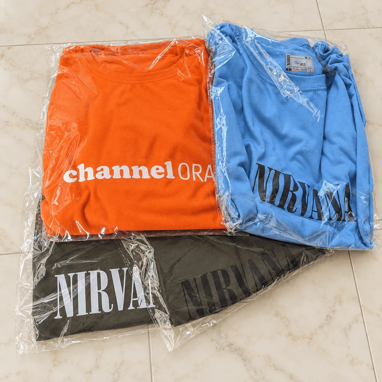 Packaged streetwear collection with Channel Orange and Nirvana graphic tees